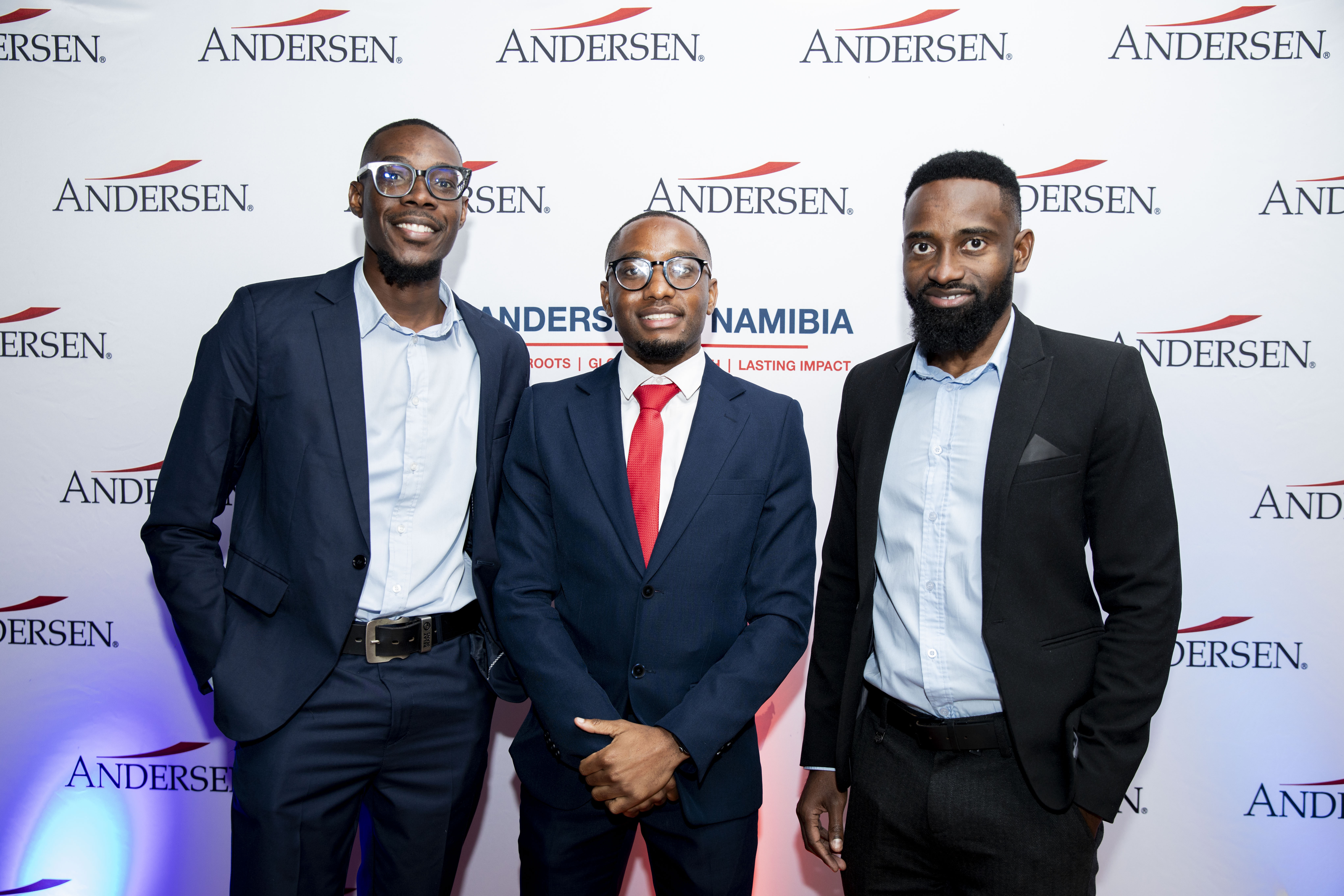 Andersen in Namibia team members at the brand wall